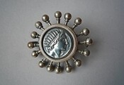 Roman silver coin in 19th c. brooch with Sol